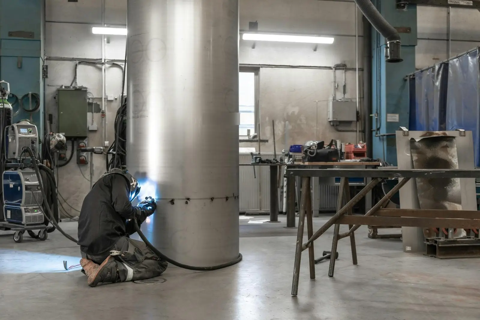 Welder fabricating a steel shell